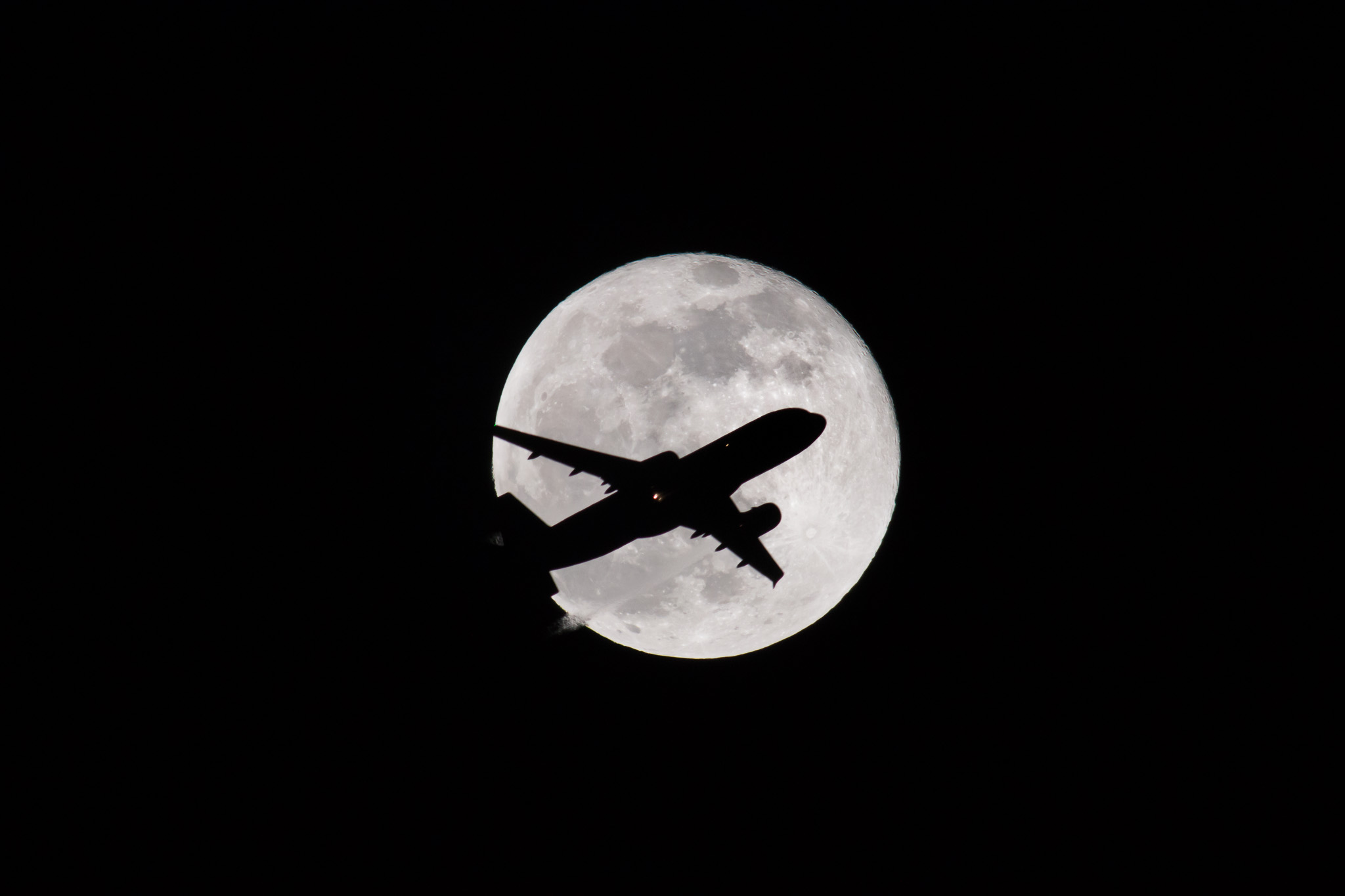 As it got later and later, fewer planes were passing by.  We were about to call it a night when a couple more were spotting inbound on the plane tracking app.  The first few missed, but then this guy brilliantly flew right across the moon!